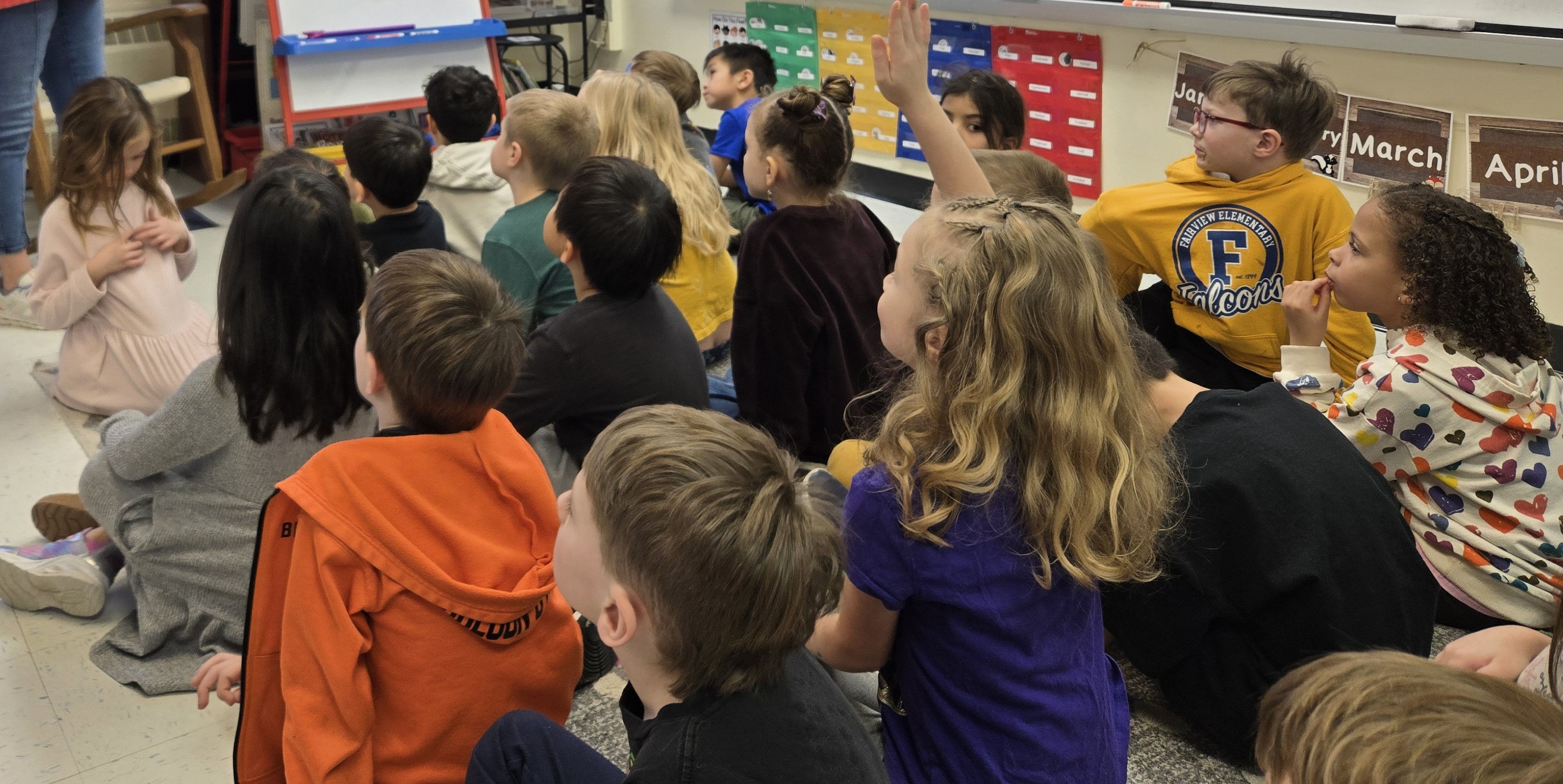 students listening on carpet